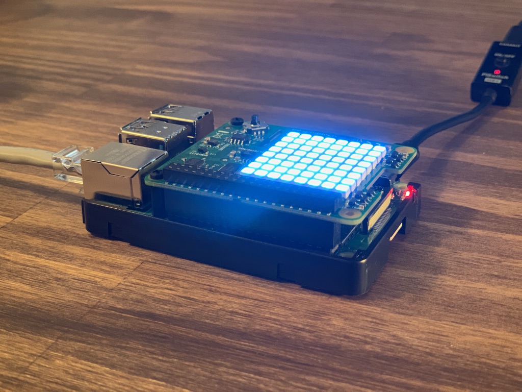 Raspberry Pi with blue andon color on Sense HAT that matches Pingum status color